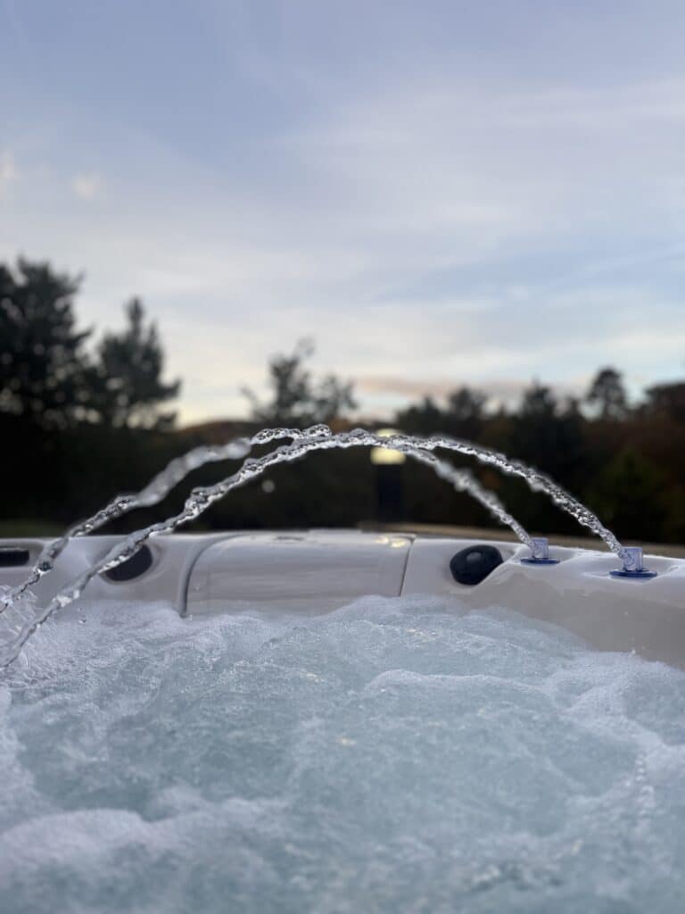 Private outdoor Jacuzzi at the Bull of the Mesanges at sunset, surrounded by nature in the Drôme